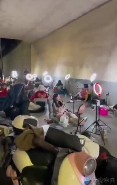 Streamers working under an overpass in a wealthy neighborhood to game location-based search and algorithms, in hopes of more and higher donations.