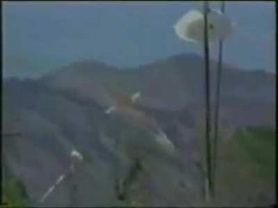 A firefighting C-130 has both its wings ripped off and crashes