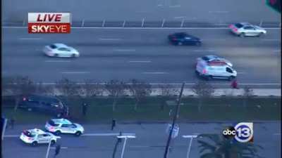 the hungry tow trucks wait their turn as the cruisers block the carcass