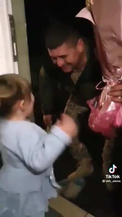 In her best dress a little girl waits at the door for her AFU enlisted Father returning on leave from the frontlines...