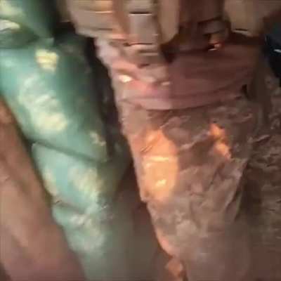 Brazilian soldier from the International Legion running in the trench to help evacuate a wounded soldier while the position is bombarded by artillery, forest near Kreminna. June 2024