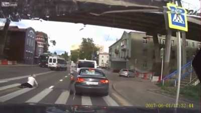 Woman talks on the phone while crossing, gets hit by car.