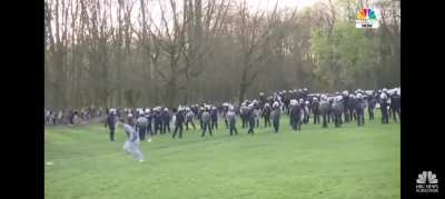 Dude kicks football at Belgium police then Naruto runs away.