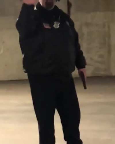 Security Guard points gun at skateboarders.