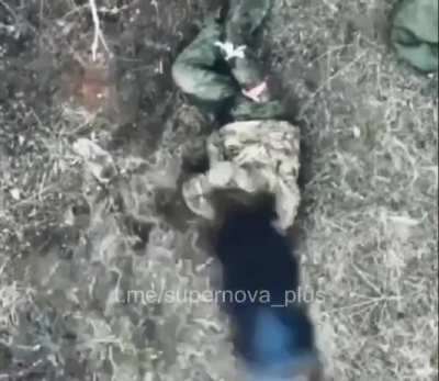 Ukrainian drone drops munitions on a Russian soldier hiding under a tarp