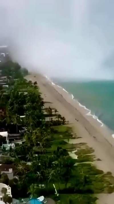 Waterspout making it's way down a beachfront