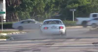 Dumbass in a Miata speeds toward a busy street