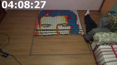 A guy made a portrait of rick Ashley using 720 Rubik's cubes