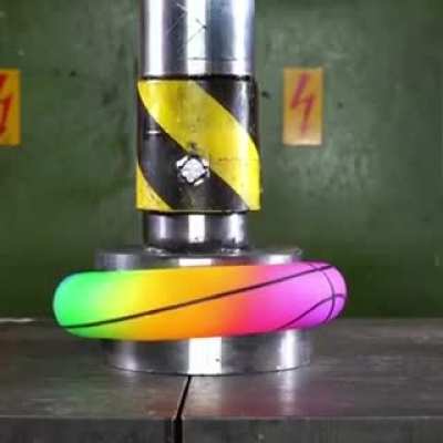 Crushing a ball with a hydraulic press