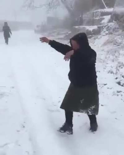 Babushkas calling for their friend to come out and play in the snow