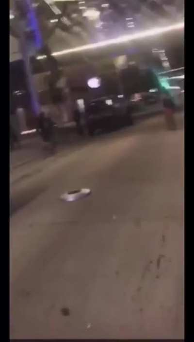 Alternate view of cop taking a hubcap to the head/helmet.
