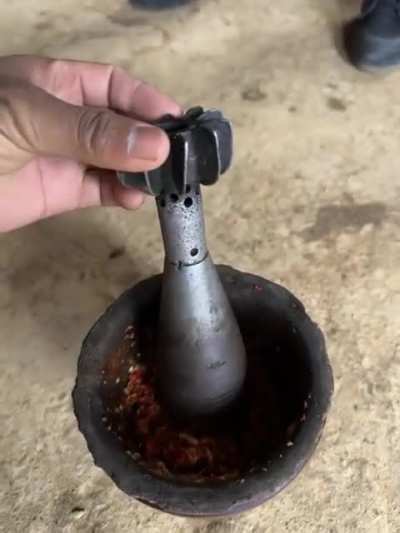 My grandma grinds spices with this old tool