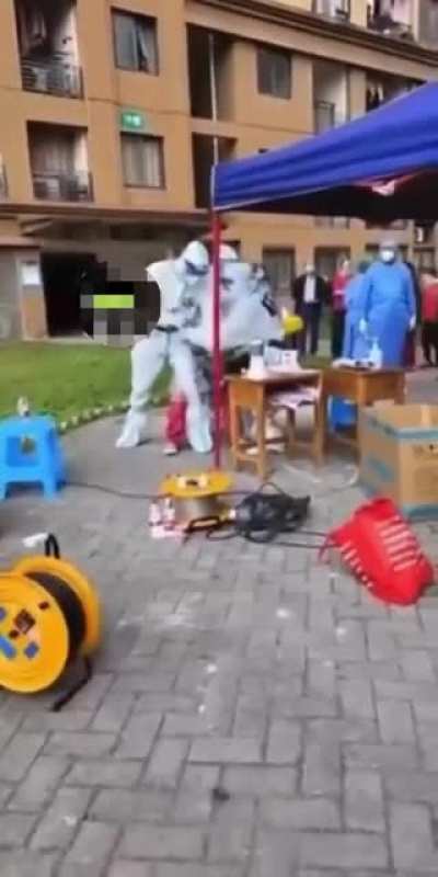 Public health officials in China Forcing a woman to take an anal swab