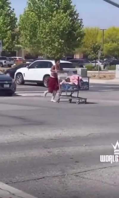 Woman joins cars in traffic with a shopping cart