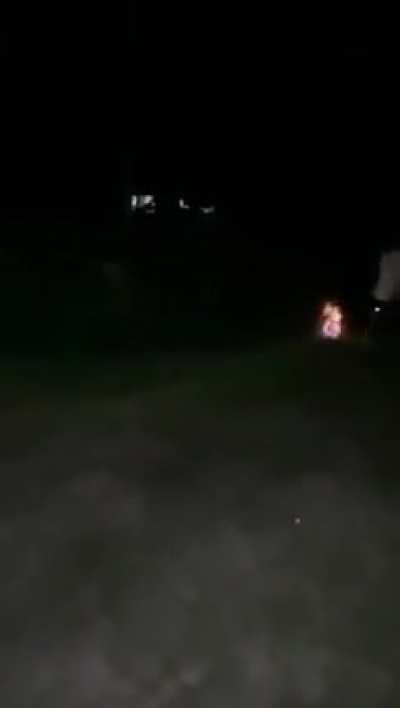 Guys lighting up a soccer ball and passing it around