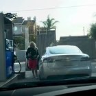 A blond and a Tesla