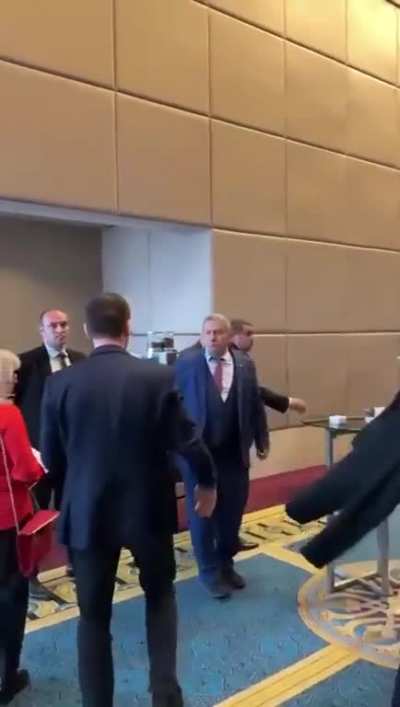 Russian diplomat attempts to steal a Ukrainian flag.