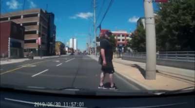Trying to stare down a driver while jaywalking