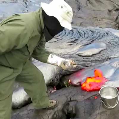 This is how geologists collect lava samples from an active volcano.