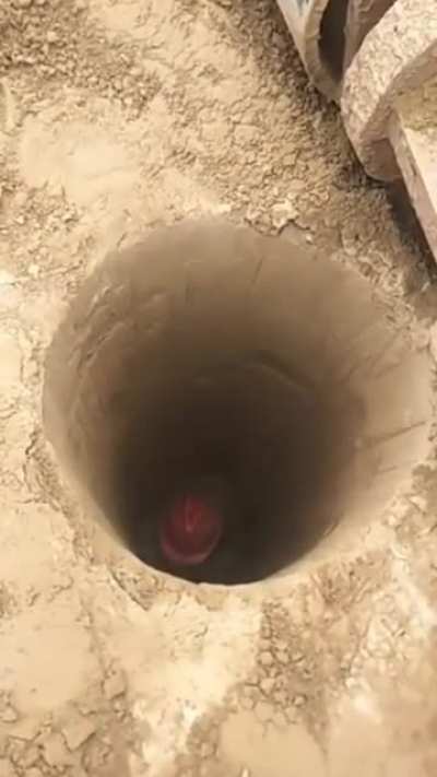 Construction worker going into a deep hole