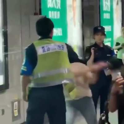 To ask a passenger to undergo security screening at the ticket gate of Shenzhen Metro Station