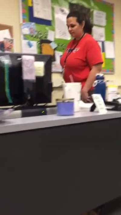 Student hiding in teachers desk