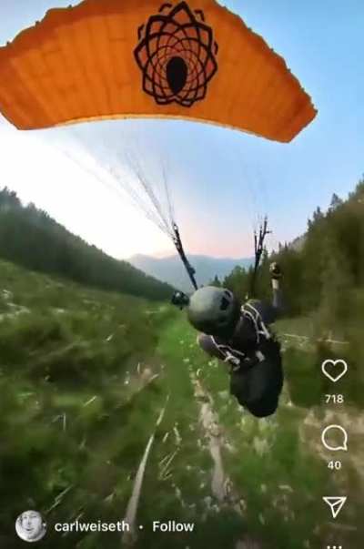 Having fun with a parachute along a mountain.