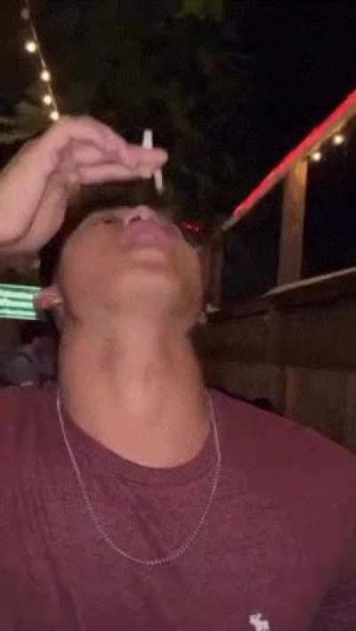 Holding A Cigarette Up To Your Mouth