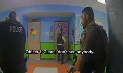 Newly released body camera video shows Texas law enforcement at the scene of the Uvalde school massacre discussing the need to confront the gunman over a period of more than 70 minutes.