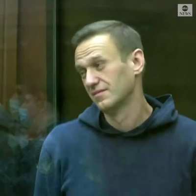 Alexey Navalny makes a heart gesture as his wife and supporters look on while a Russian court orders the opposition leader to more than two years in a prison camp.