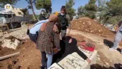 screaming “Leave me to die with him”, Israeli forces attacking and forcibly pulling a Palestinian mother from her son's grave as she tried to prevent them from destroying the grave