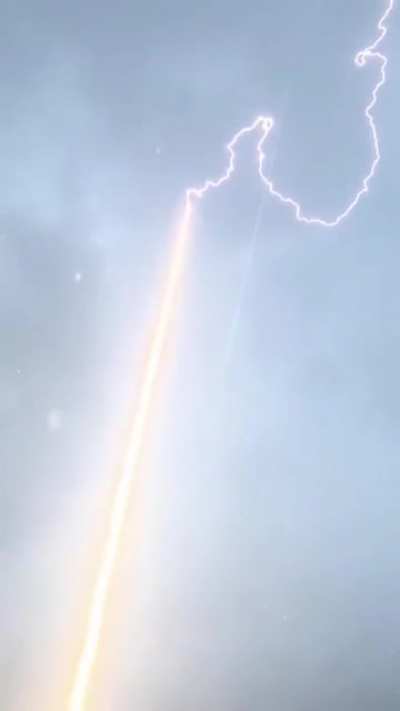Lightning Bolt Is Guided To Ground Through Rocket Trail