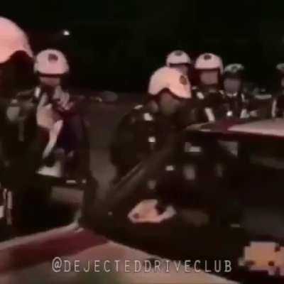 Japanese police attempting to barricade bosozoku gang.