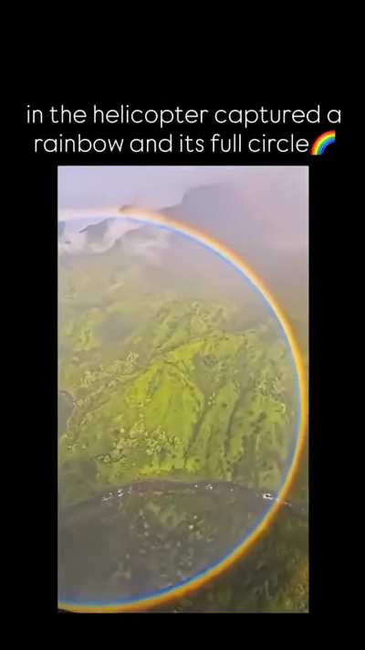 Capturing a full rainbow while sitting in a helicopter.