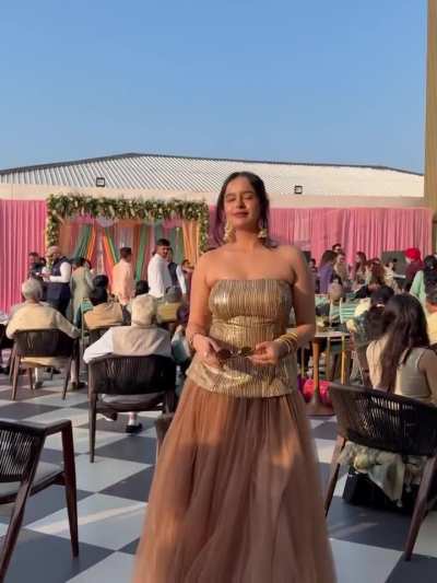 Gauri Bhasin in metallic gold strapless peplum corset top paired with a chocolate brown tulle maxi skirt