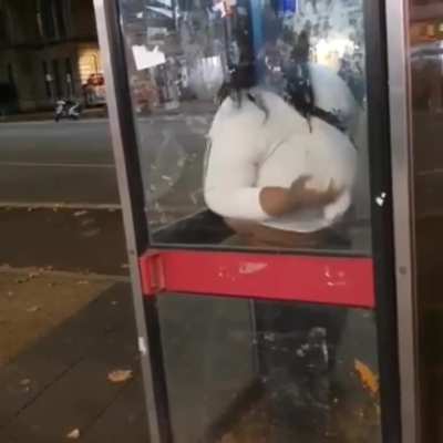 Lady NPC having a shit in a phone box