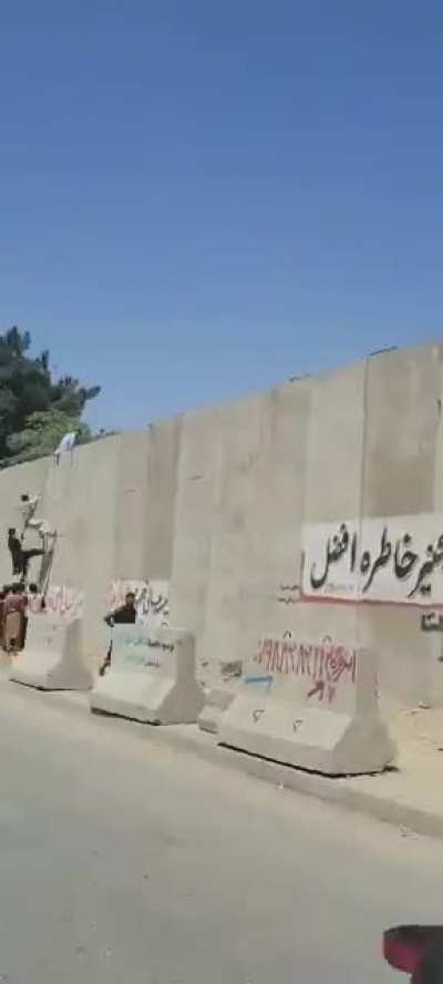 Afghani civilians trying to escape the Taliban are climbing the walls of Kabul's Airport in an attempt to get inside