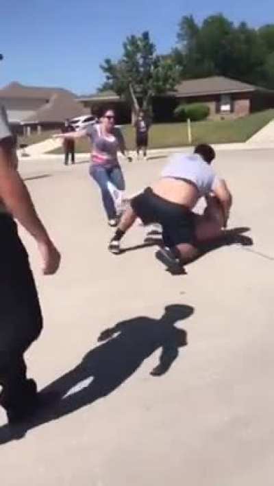Two guys try to take down a wrestler