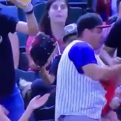 Man holding baby in one hand and beer in the other, drops baby to catch a baseball.