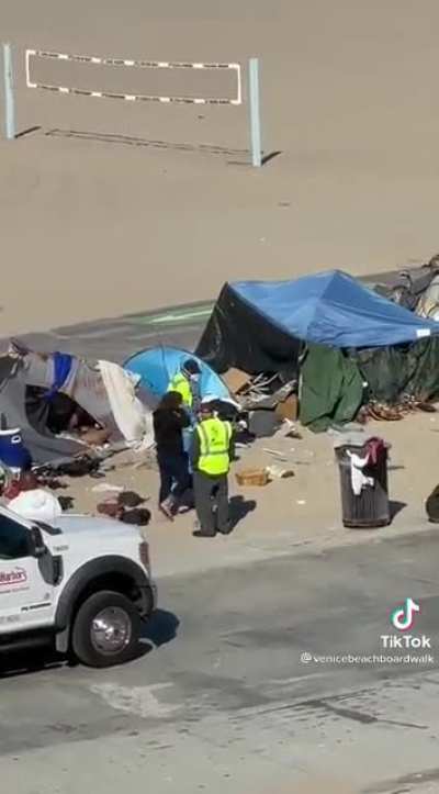 Workers on the boardwalk try to encourage the homeless to voluntarily clean up and move out