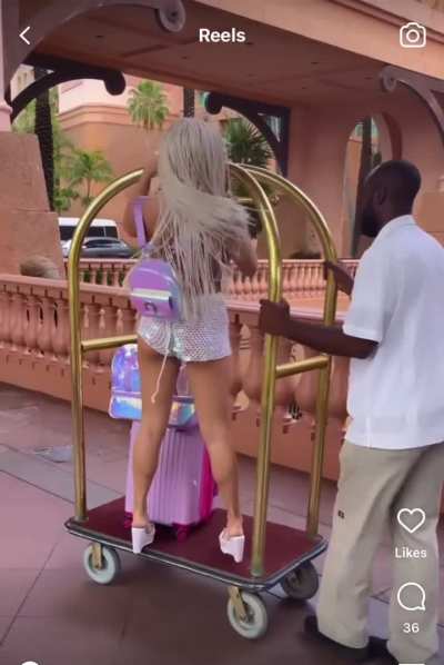 The workers look so annoyed. The one guy even shakes his head “no” when she’s on the luggage cart