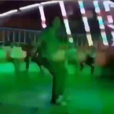 person dances on spinning ride at carnival