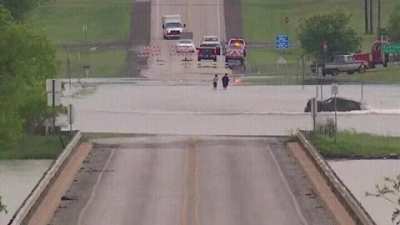 Idiot ignores barriers and crosses flooded street!