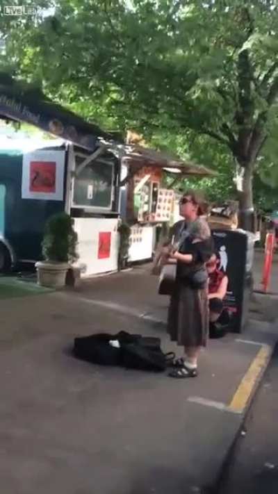 Girl plays guitar and sings about offering someone a blowjob if they buy her coffee