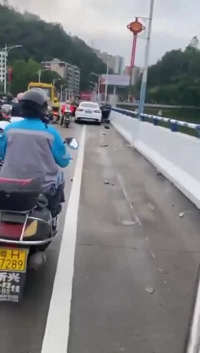 Aftermath of car colliding onto motor<wbr>cycle<wbr>s/mop<wbr>eds on a bridge. At first you see only 1 cyclist but the farther you go the more you see.
