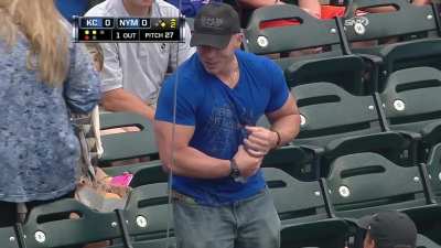 In 2013 this fan at a Mets game attempts to open a water bottle