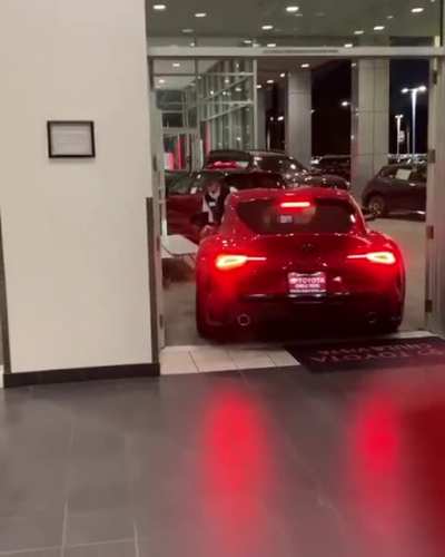Salesperson drives customer's new Supra into a bench halfway off the showroom floor