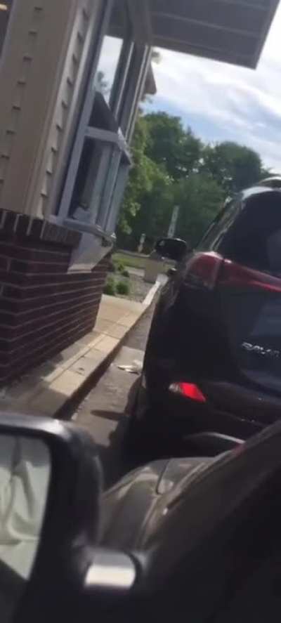 Woman upset at Dunkin’ Donuts gets a face full of iced coffee and banshee screams.
