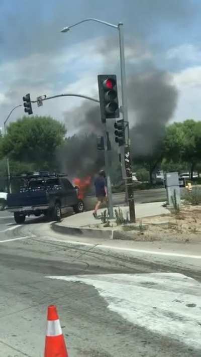 Raging car fire. Dude crosses the street like nothing is happening.