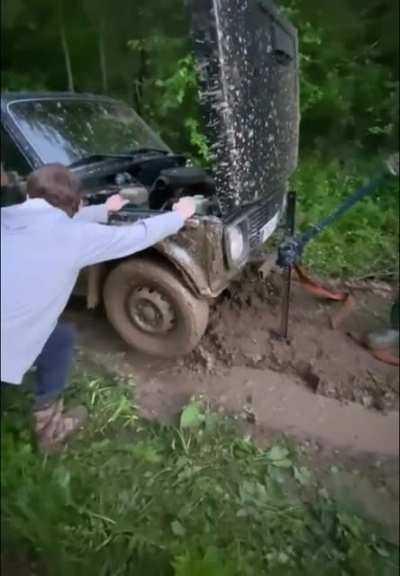 Getting the car out of the mud.